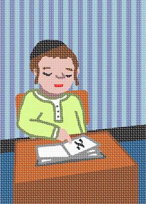 A young Jewish boy sitting at his desk in school points to the place in his workbook.