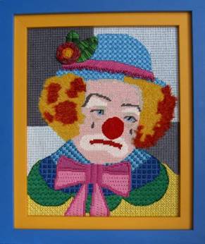 Sad but happy. "Down Clown" in his colorful new frame.